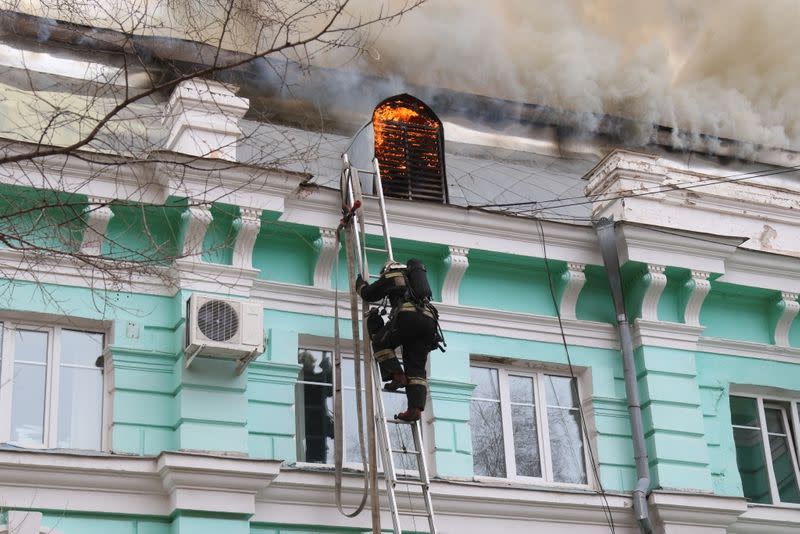 Firefighters work to extinguish a fire at a hospital in Blagoveshchensk