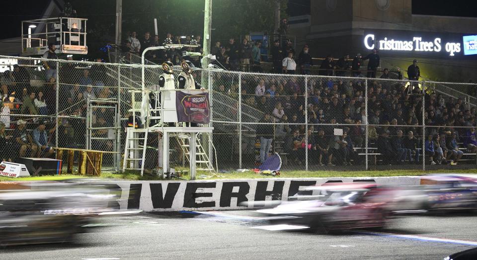 Cars drive past the Riverhead race wall logo during the Eddie Partridge 256 for the Whelen Modified Tour at Riverhead Raceway on September 17, 2022 in Riverhead, New York. (Mike Lawrence/NASCAR)