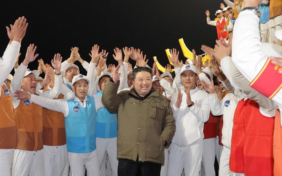 Mr Kim with scientists and technicians at the National Aerospace Technology Administration who were behind the mission