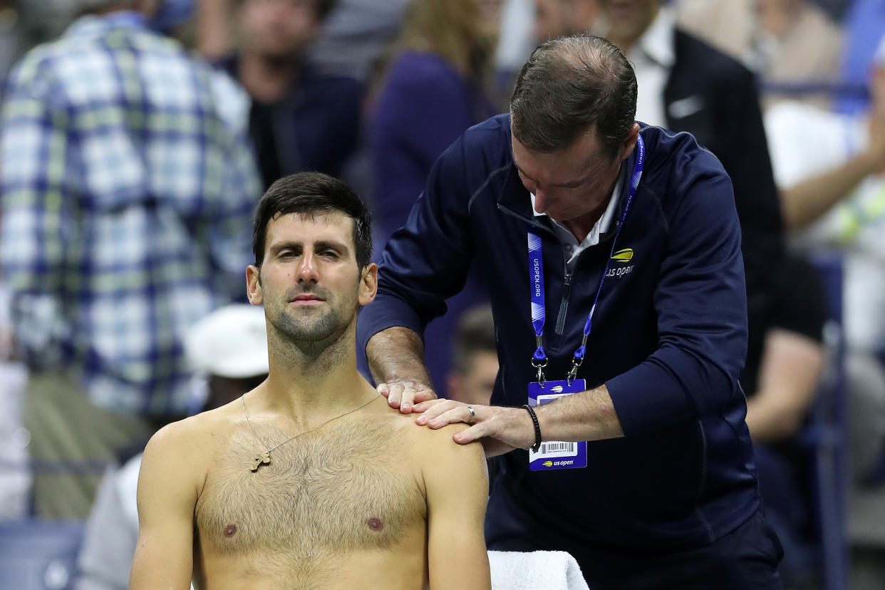 Novak Djokovic fell to Switzerland's Stan Wawrinka on Sunday night, retiring early due to a left shoulder injury in the third set of their fourth round match at the US Open.