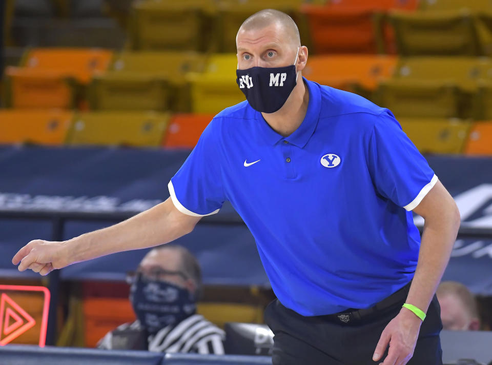 FILE - In this Saturday, Dec. 5, 2020 file photo, BYU head coach Mark Pope talks to his team during the first half of an NCAA college basketball game against Utah State in Logan, Utah. Heading into the season, there wasn't a lot of talk about No. 23. BYU. This was supposed to be a rebuilding season in Provo, Utah for coach Mark Pope and his Cougars. Guess again. BYU went 20-6 playing with a returning senior guard, three transfers and a freshman and they seemingly are getting better heading into their first NCAA Tournament since 2015.(Eli Lucero/The Herald Journal via AP, Pool)