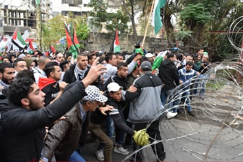 A group of demonstrators gather near the police barricades to enter U.S. Embassy in Beirut - Credit: Furkan Guldemir/Anadolu Agency/Getty Images