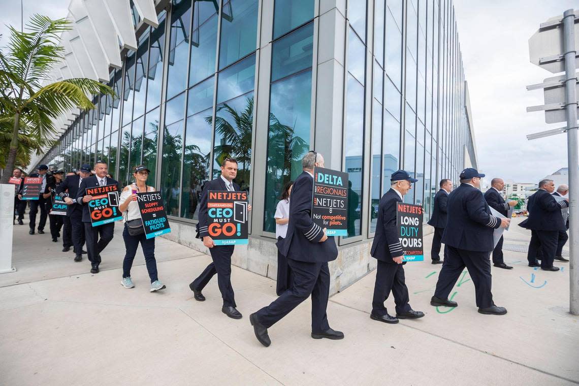 Netjets pilots picketing for better contracts in front of Art Basel Miami Beach.