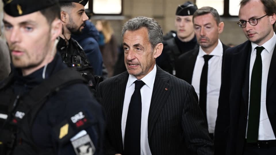 France's former president Nicolas Sarkozy (C) arriving at a Paris court for the verdict in his appeal trial in the so-called Bygmalion case in February. - Bertrand Guay/AFP/Getty Images