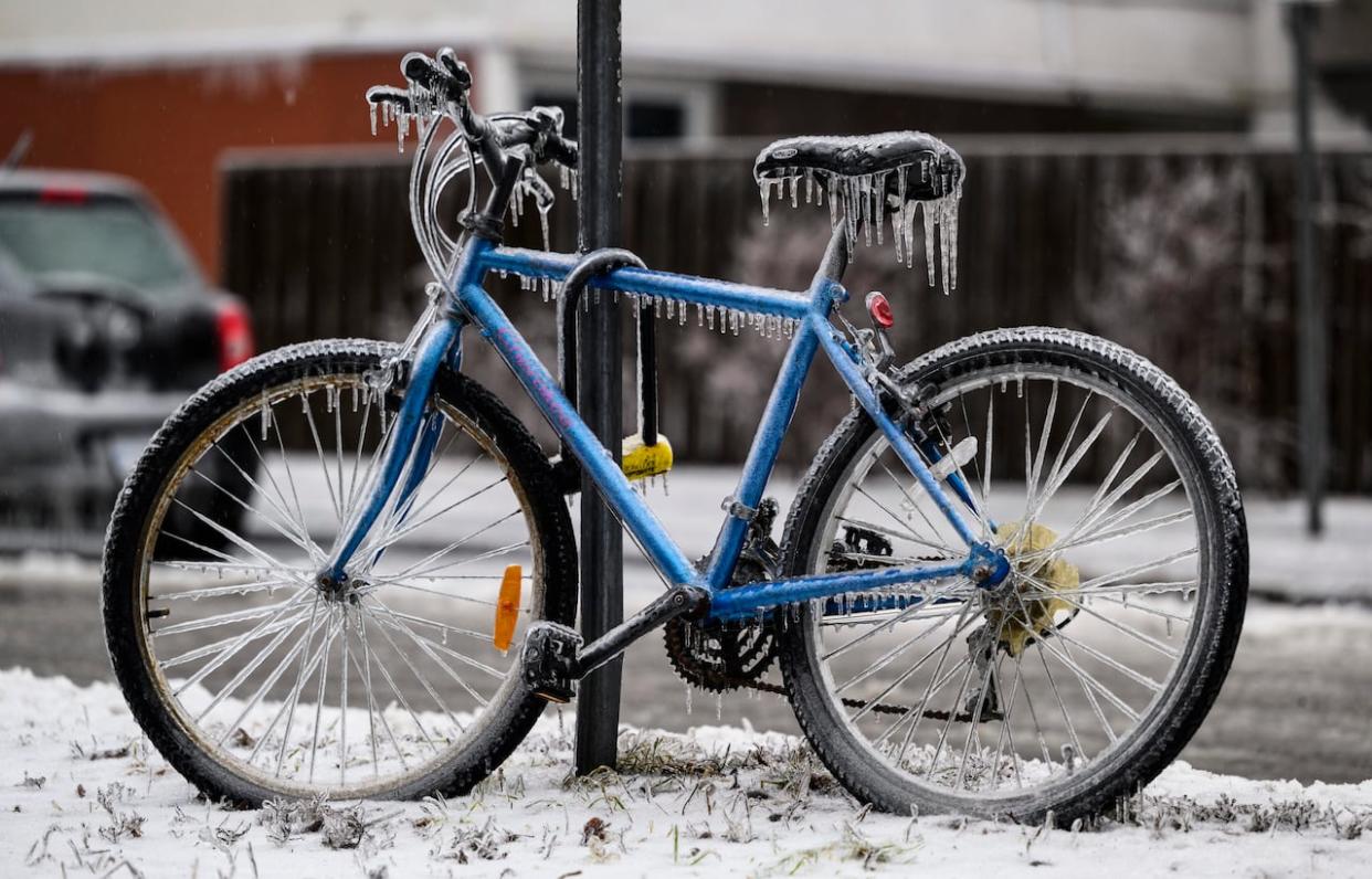Icicles cover a bicycle after a freezing rain storm in Ottawa last April. More ice buildup is forecast overnight. (Justin Tang/The Canadian Press - image credit)