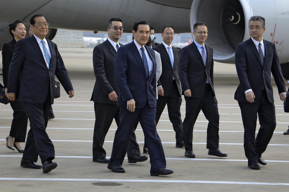In this photo released by the Ma Ying-jeou Office, Former Taiwan President Ma Ying-jeou, center, walks with his delegation as he arrives at the Pudong airport in Shanghai, China, Monday, March 27, 2023. Ma departed for a tour of China on Monday, in what he called an attempt to reduce tensions a day after Taiwan lost one of its few remaining diplomatic partners to China. (Ma Ying-jeou Office via AP)