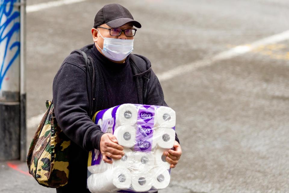 MELBOURNE, AUSTRALIA - MAY 09: A man wearing a face mask carries a large pack of toilet paper in the CBD during the Coronavirus (COVID-19) pandemic on May 09, 2020, in Melbourne, Australia. (Photo by Speed Media/Icon Sportswire)