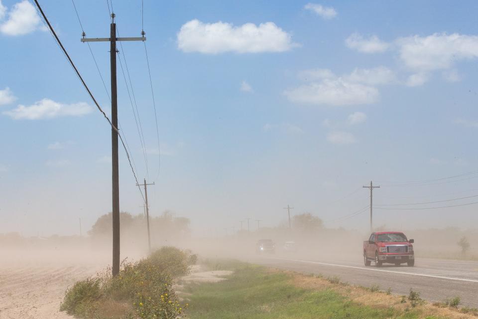 Vehicles drive through blowing sand and dust from an arid field on Highway 359 near Mathis, Texas, on Aug. 3, 2022. The city of Corpus Christi provides water to 500,000 Coastal Bend residents, including customers throughout San Patricio County.