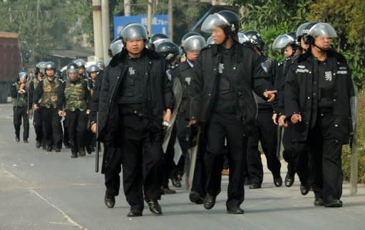 Chinese riot policemen patrol the streets after villagers protested over pollution from a coal-fired power station in the town of Haimen, Guangdong Province in December 2011. Social unrest is a major problem for China's communist rulers, who are struggling to deal with anger across the vast nation of 1.3 billion people over issues such as environmental degradation, rising inequality and graft