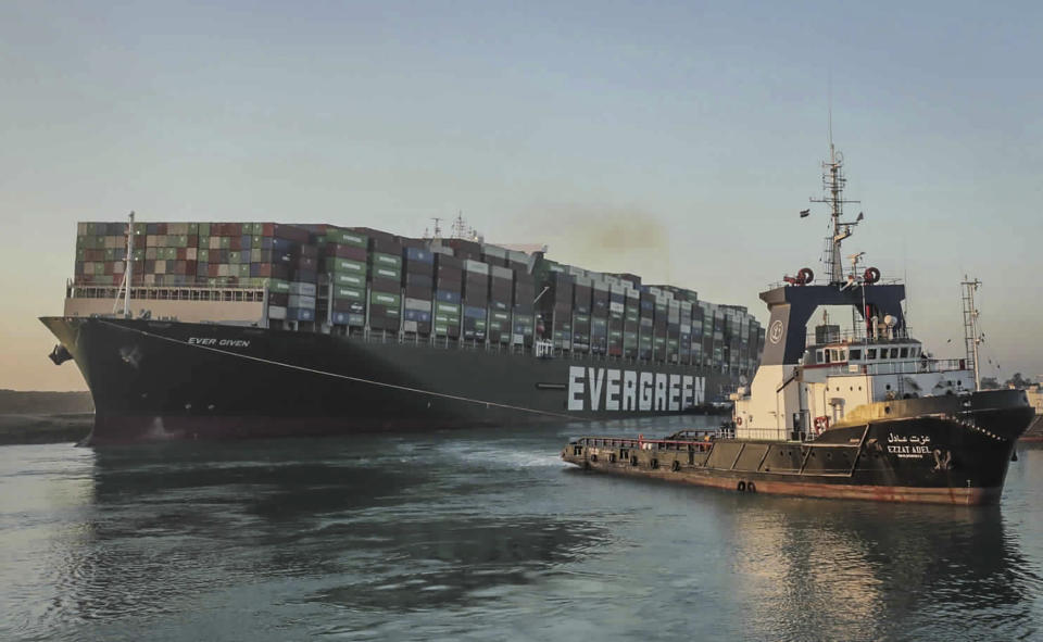 FILE - In this photo released by Suez Canal Authority, the Ever Given, a Panama-flagged cargo ship, is pulled by one of the Suez Canal tugboats, in the Suez Canal, Egypt, on March 29, 2021. The world’s biggest shipping company said Monday Feb. 13, 2023 it sued a rival shipping line in a Danish court, seeking compensation for ship delays that resulted from the blocking of the Suez Canal by a hulking vessel two years ago. (Suez Canal Authority via AP, File)