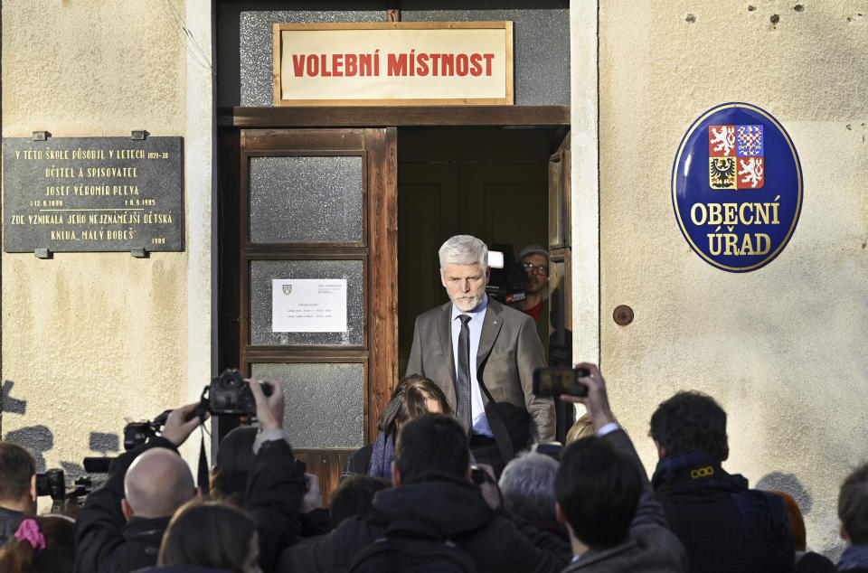 Journalists react as presidential candidate Petr Pavel leaves a polling station after voting in the first round of presidential election in Cernoucek, Czech Republic, Friday, Jan 13, 2023. Czechs have started voting for a new president, with populist billionaire Andrej Babis leading a field of eight candidates in an election to succeed Milos Zeman in the largely ceremonial post. (Ondrej Hajek/CTK via AP)