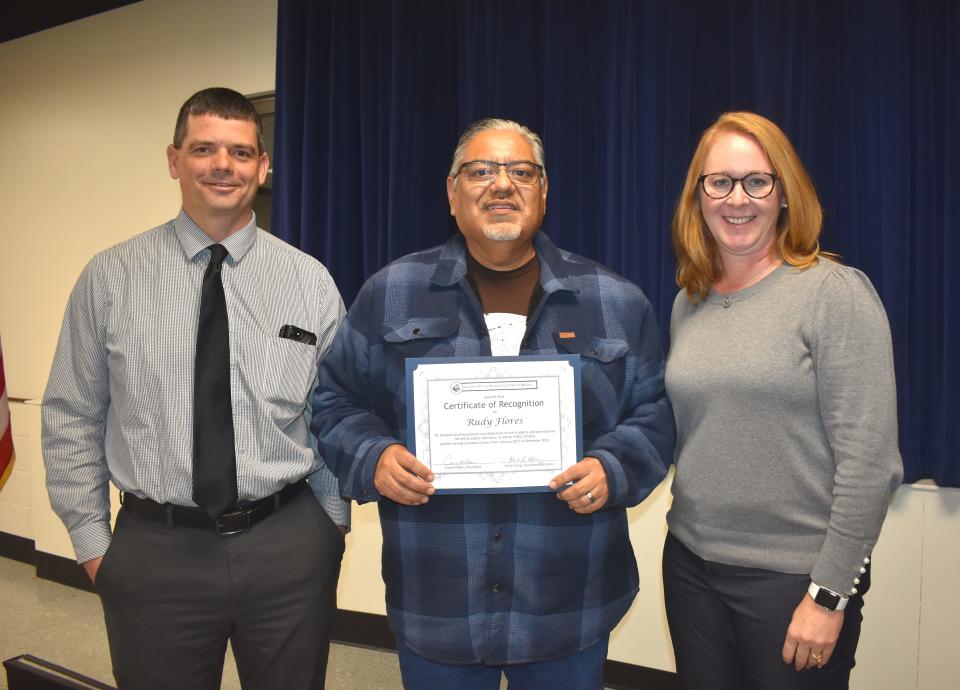 Lifelong Adrian resident and Adrian Public Schools Board of Education trustee Rudy Flores, center, displays a certificate of recognition presented to him by the Lenawee County Association of School Boards for service on the board of education as a trustee from January 2017 to this month. He is flanked by Adrian Public Schools Superintendent Nate Parker, left, and school board President Beth Ferguson at the Nov. 14 board meeting.