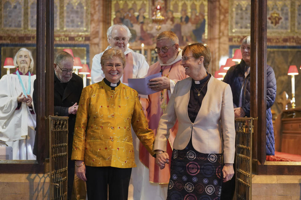 Reverend Catherine Bond, left and Reverend Jane Pearce react after being blessed, at St John the Baptist church, in Felixstowe, after the use of prayers of blessing for same-sex couples in Church of England services were approved by the House of Bishops, in Suffolk, England, Sunday, Dec. 17, 2023.. Known as prayers of love and faith, the blessings can be used as part of regular services from Sunday, after they were approved by the House of Bishops just days earlier. (Joe Giddens/PA via AP)