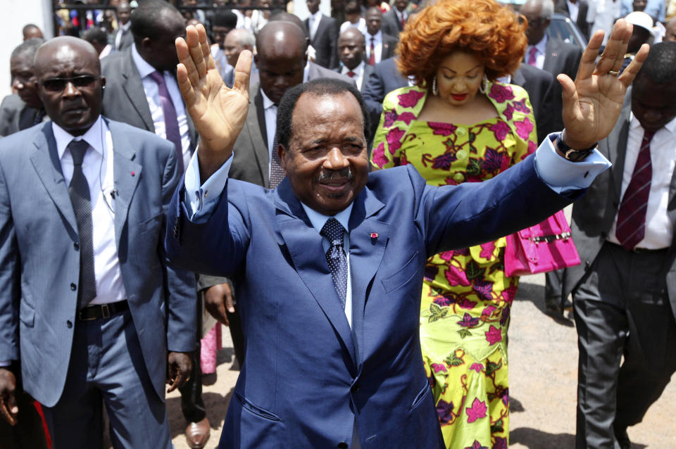 FILE - In this Sunday Oct 9, 2011 file photo, Cameroon President Paul Biya waves after casting his vote during the presidential elections in Yaounde, Cameroon. A bloody conflict between Cameroon's government and Anglophone separatists over language is now threatening next month's presidential election. The 85-year-old President Paul Biya, one of Africa's longest-serving leaders, vows to hold the largely Francophone country together even as thousands flee violence in English-speaking regions. (AP Photo/Sunday Alamba, File)