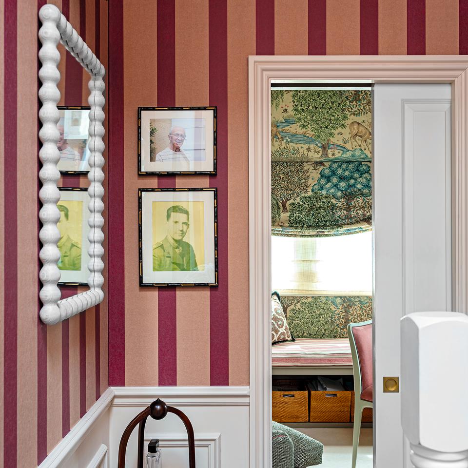 Hallway with red and pink striped wallpaper.