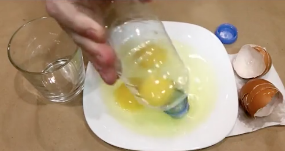 He uses a plastic bottle to suck up the egg yolks from the bowl. Photo: Storyful