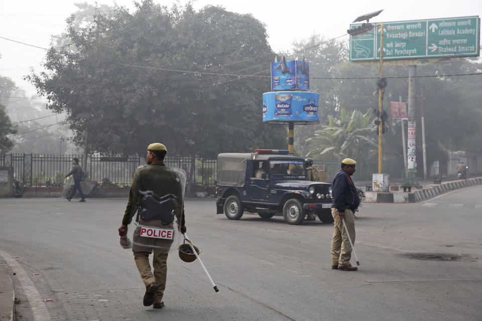 Police patrol a street in Lucknow, Uttar Pradesh state, India, Sunday, Dec. 22, 2019. Violent protests against India's citizenship law that excludes Muslim immigrants have swept the country over the weekend despite the government's ban on public assembly and suspension of internet services in many parts. Police said nine people died in clashes with security forces in Uttar Pradesh on Saturday, most of them young protesters. (AP Photo/Rajesh Kumar Singh)