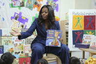 Former first lady Michelle Obama reads a book to school children during a surprise appearance at Para Los Niños on Thursday, Nov. 15, 2018, in Los Angeles. (Photo by Willy Sanjuan/Invision/AP)