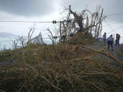 <p>A resident ducks under a downed power line in the aftermath of Hurricane Irma in Tortola, in the British Virgin Islands, on Sept. 7, 2017. (Photo: Jalon Manson Shortte via AP) </p>