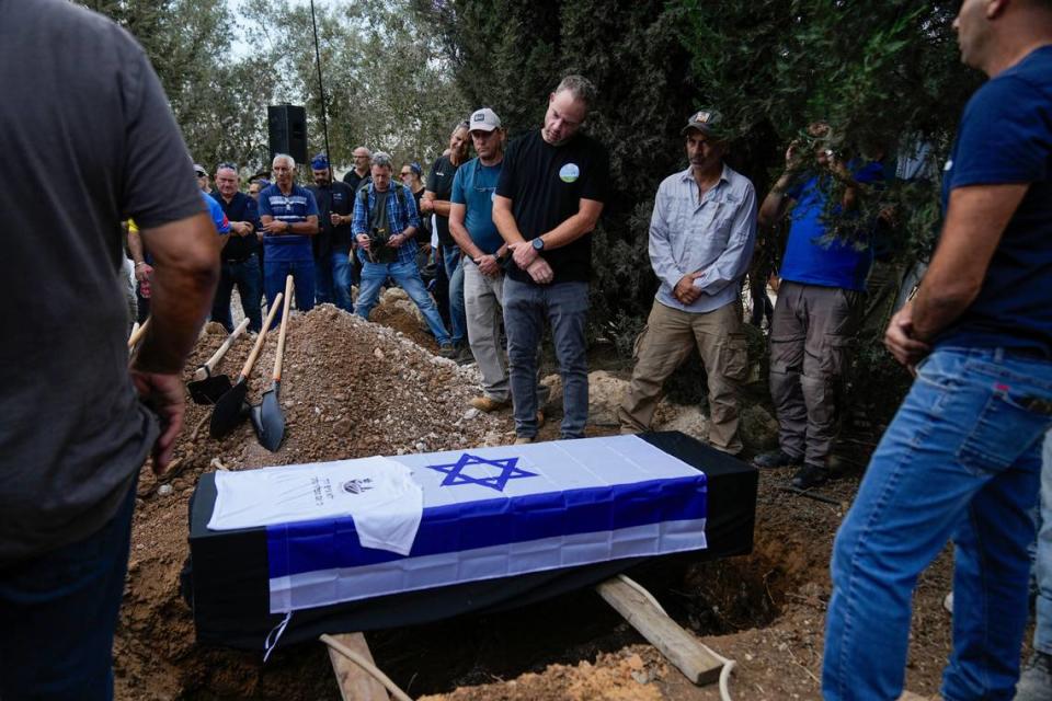 Mourners gather around the coffin of Yosef Vahav, 65, during his funeral in Beit Guvrin, Israel, Tuesday, Oct. 31, 2023. Vahav was killed by Hamas militants on Oct. 7 in Kibbutz Nir Oz near the border with the Gaza Strip. More than 1,400 people were killed and some 220 captured in an unprecedented, multi-front attack by the militant group that rules Gaza.