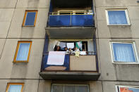 A Roma family gathers at the balcony of their apartment at the Avas apartment projects in Miskolc, 180 km (112 miles) east of Budapest, October 17, 2012. The city's ex-communist Avas housing projects, home to about 40,000 people, have seen mass immigration of destitute Roma from the countryside, where living conditions are often rustic. Long-time residents have shunned the new Roma occupants, many of whom have large families crammed into tiny flats. Picture taken October 17. To match story HUNGARY-FARRIGHT/ REUTERS/Laszlo Balogh (HUNGARY - Tags: POLITICS CIVIL UNREST REAL ESTATE BUSINESS SOCIETY IMMIGRATION)