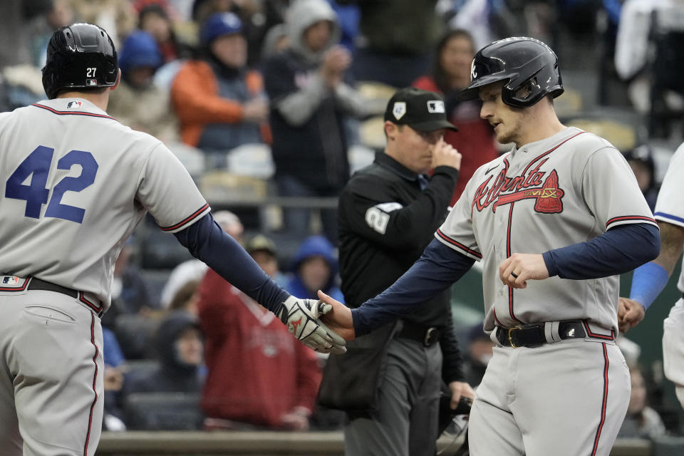 Atlanta Braves' Austin Riley, left, and Sean Murphy celebrate after scoring on a single hit by Ozzie Albies during the third inning of a baseball game against the Kansas City Royals Saturday, April 15, 2023, in Kansas City, Mo. (AP Photo/Charlie Riedel)
