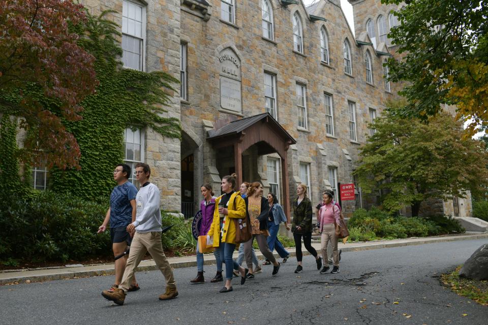 WPI graduate workers walk by Boynton Hall - the college's administration building - to join others for a rally to unionize Monday in Worcester.