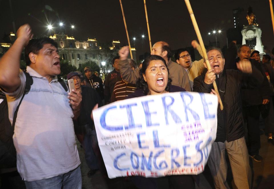 Demonstrators protest against congress, at San Martin Plaza in Lima, Peru, Thursday, Sept. 26, 2019. Congressmen in Peru rejected President Martin Vizcarra's proposal to push forward elections to choose his successor.(AP Photo/Martin Mejia)