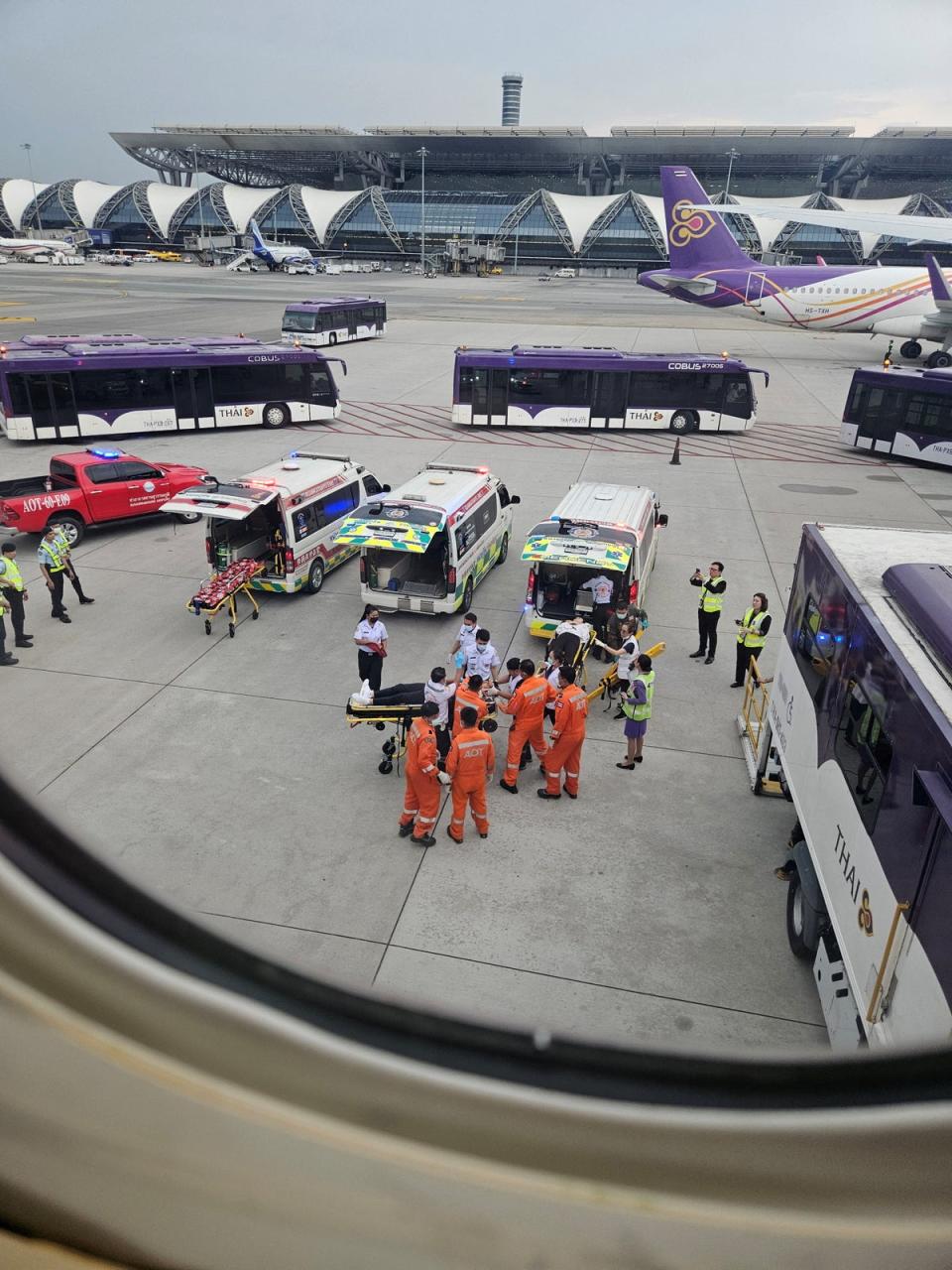 Staff members carry people on stretchers at Bangkok's Suvarnabhumi International Airport (via REUTERS)