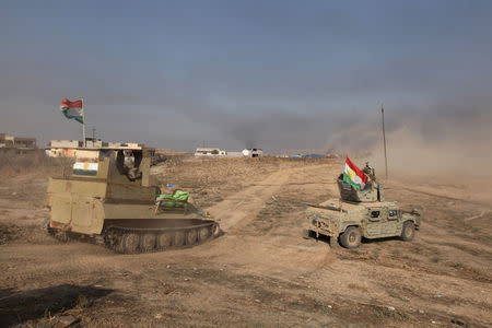 Military vehicles of Peshmerga forces drive towards the town of Bashiqa, east of Mosul, during an operation to attack Islamic State militants in Mosul, Iraq, November 7, 2016. REUTERS/Azad Lashkari