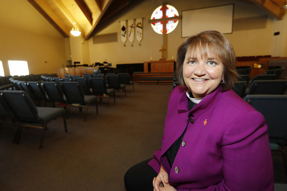 This Wednesday, April 19, 2017 photo shows Bishop Karen Oliveto in the sanctuary of a United Methodist Church near her office in Highlands Ranch, Colo. She was elected by the Rocky Mountain regional body in 2016 as the UMC's first openly lesbian bishop. The UMC's judicial council upheld the election result, while ruling that Oliveto's 2014 marriage to a woman violated UMC policies for its clergy. (AP Photo/David Zalubowski)