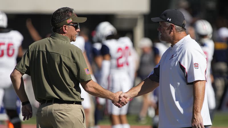 Arizona head coach Jedd Fisch, left, and Utah head coach Kyle Whittingham talk before a Pac-12 game on Nov. 13, 2021, in Tucson, Ariz. The two coaches will meet up again Saturday in the desert.