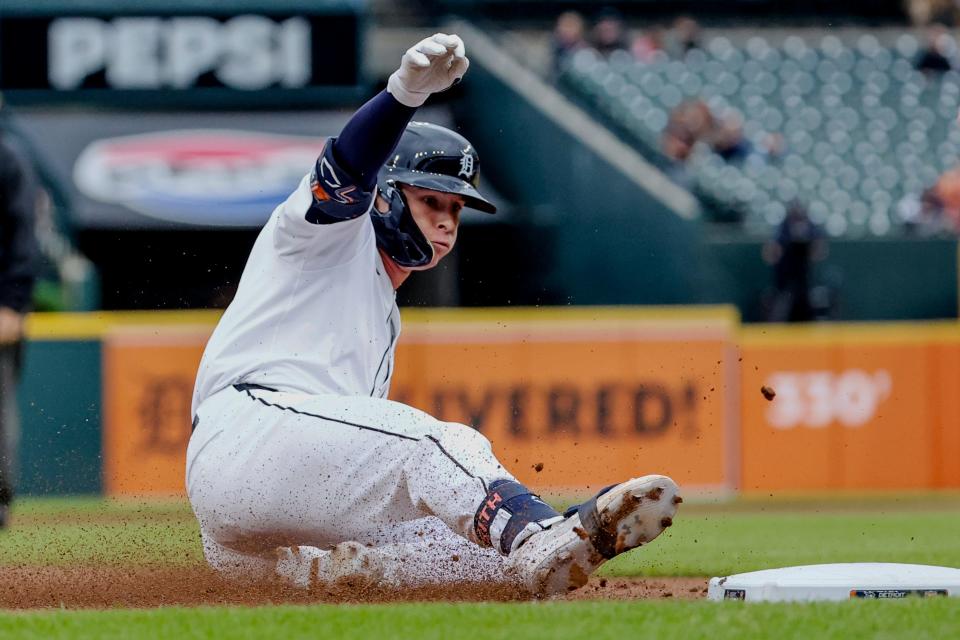 Detroit Tigers second baseman Colt Keith (33) slides into third after hitting a RBI triple in the first inning against the Cleveland Guardians at Comerica Park in Detroit on Wednesday, July 10, 2024.