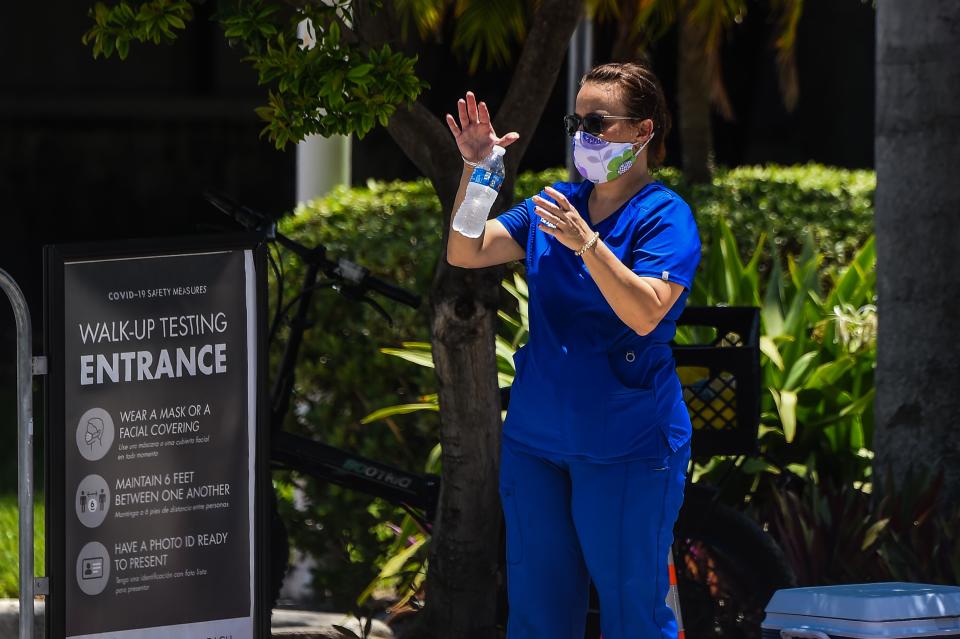 A woman waits for her testing at a "walk-in" and "drive-through" coronavirus testing site in Miami Beach, Florida on June 24, 2020. - With coronavirus cases surging across the US South and West, officials are once again imposing tough measures, from stay-at-home advice in worst-hit states to quarantines to protect recovering areas like New York. Nearly four months after the United States reported its first death from COVID-19, the nation faces a deepening health crisis as a wave of infections hits young Americans and experts issue new acute warnings. (Photo by CHANDAN KHANNA / AFP) (Photo by CHANDAN KHANNA/AFP via Getty Images)