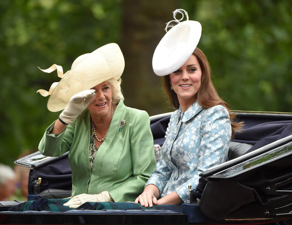 <p>For her first appearance since giving birth to Princess George, Kate Middleton went for a floral blue coat to blend well with Camilla's green.</p>