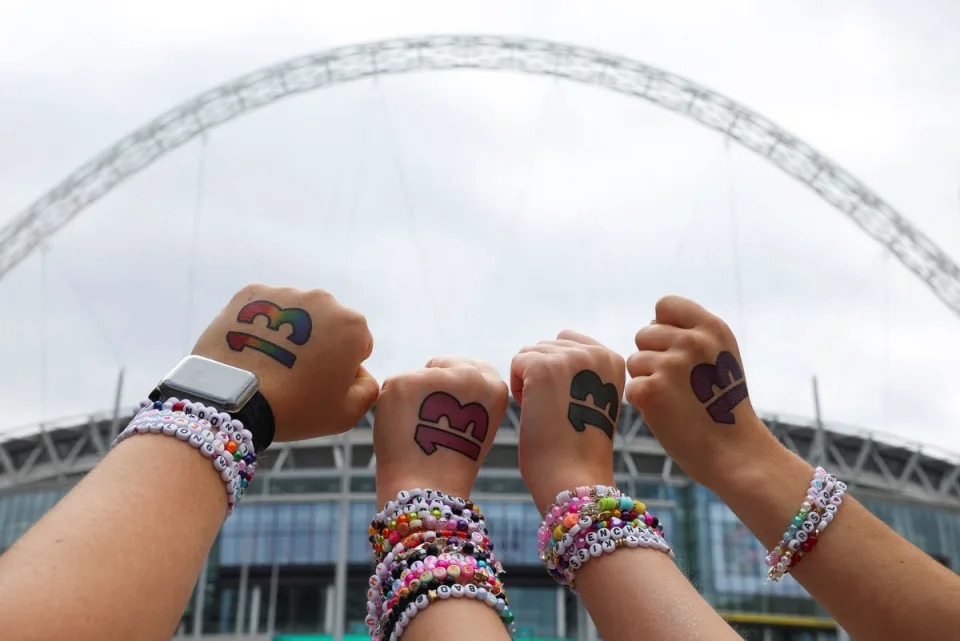 Fans show off their friendship bracelets at Wembley Stadium (REUTERS)