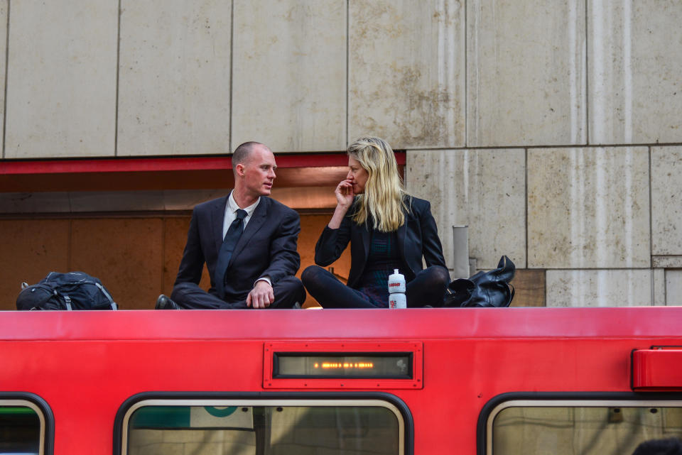 Two climate change protesters sit with their hand glued to the roof of a DLR train carriage at Canary Wharf DLR on April 17. (PA)