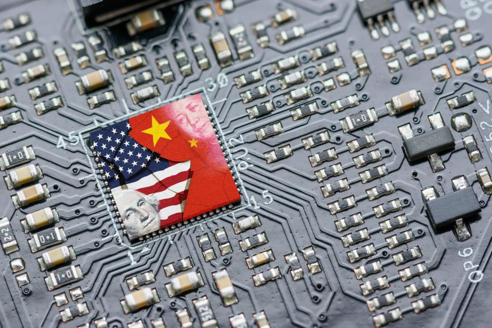 A printed circuit board with the flags of the US and China on a chip.