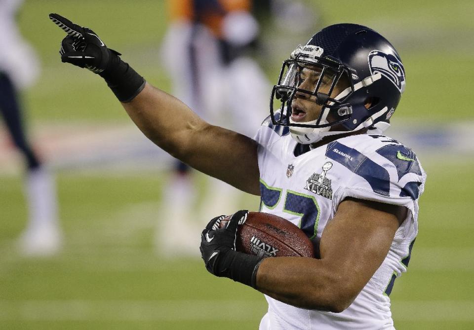 Seattle Seahawks outside linebacker Malcolm Smith (53) reacts after running back an interception for a touchdown against the Denver Broncos during the first half of the NFL Super Bowl XLVIII football game, Sunday, Feb. 2, 2014, in East Rutherford, N.J. (AP Photo/Chris O'Meara)