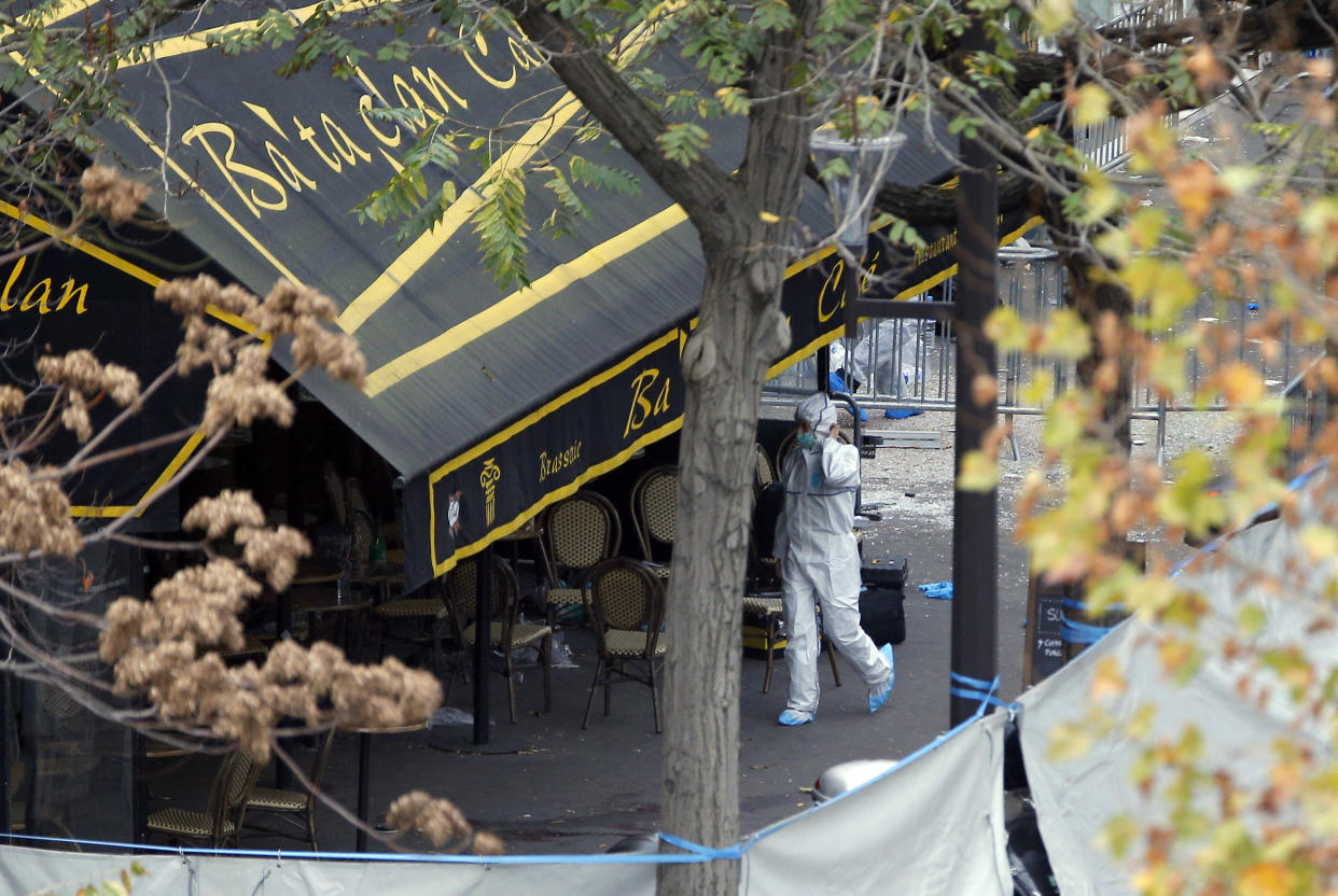 FILE - An investigator works outside the Bataclan concert hall, Nov. 14, 2015 in Paris. The historic trial in Paris of 20 men suspected of critical roles in the Islamic State massacres that killed 130 people in 2015 has ended this week with verdicts against the defendants in France's worst peacetime attack expected on Wednesday June 29. (AP Photo/Christophe Ena, File)