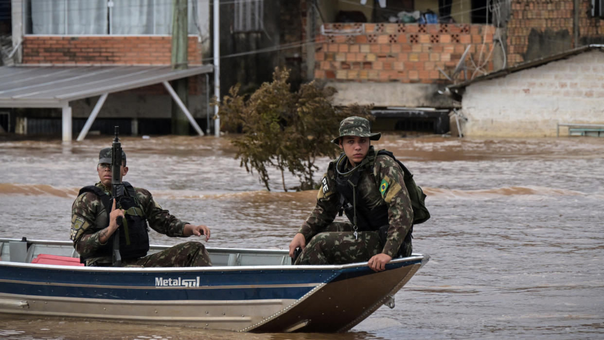  Brazilian Army soldiers patrol Porto Alegre neighborhoods amid deadly flooding. 