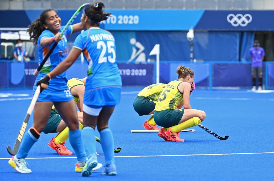 Australia's Kaitlin Nobbs (R) and Stephanie Anna Kershaw (back) react after losing 1-0 to India as India's Neha (L) and Navneet Kaur celebrate at the end of their women's quarter-final match of the Tokyo 2020 Olympic Games field hockey competition, at the Oi Hockey Stadium in Tokyo, on August 2, 2021. (Photo by CHARLY TRIBALLEAU / AFP) (Photo by CHARLY TRIBALLEAU/AFP via Getty Images)