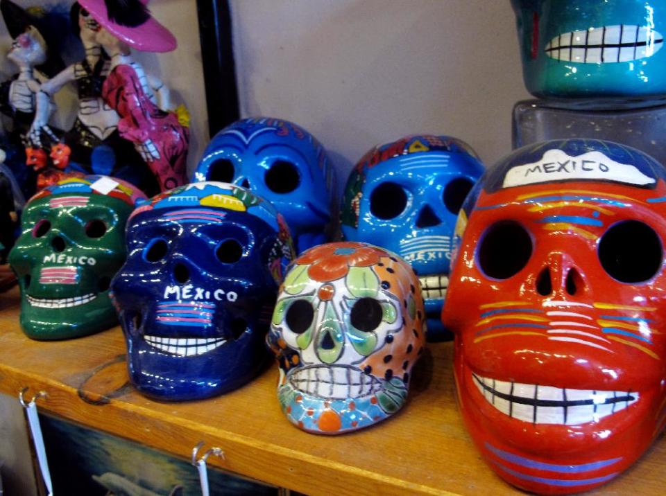 In this May 8, 2013 photo, artwork is shown at Masks y Mas, an Albuquerque shop that sells 'Day of the Dead' art year round. Disney announced Tuesday that it was a withdrawing a "Dia de los Muertos" trademark request it made to the U.S. Patent and Trademark Office amid uproar on social media from Latino activists, writer and artists. Disney had sought to secure naming right for an upcoming animated movie inspired by the holiday. Critics said the move to trademark a cultural holiday was insensitive. (AP Photo/Russell Contreras)