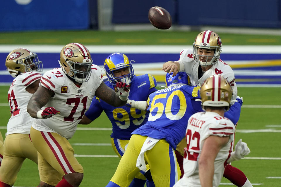 San Francisco 49ers quarterback Nick Mullens (4) throws under pressure during the first half of an NFL football game against the Los Angeles Rams Sunday, Nov. 29, 2020, in Inglewood, Calif. (AP Photo/Alex Gallardo)