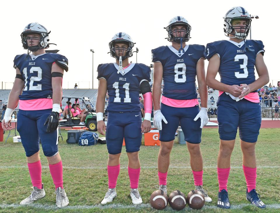 Parrish's team captains, Gage Cameron (12), Holten Graham (11), Lane Tomlinson (8) and Jackson Volz (3). Parrish Community High School Bulls win 35 to 28 over Braden River High Pirates during a district home game at the Bulls stadium Friday night, Oct. 13, 2023, in Parrish.