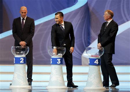 Former Italy soccer player Fabio Cannavaro (C) draws a ball from a pot during the draw for the 2014 World Cup at the Costa do Sauipe resort in Sao Joao da Mata, Bahia state, December 6, 2013. REUTERS/Sergio Moraes