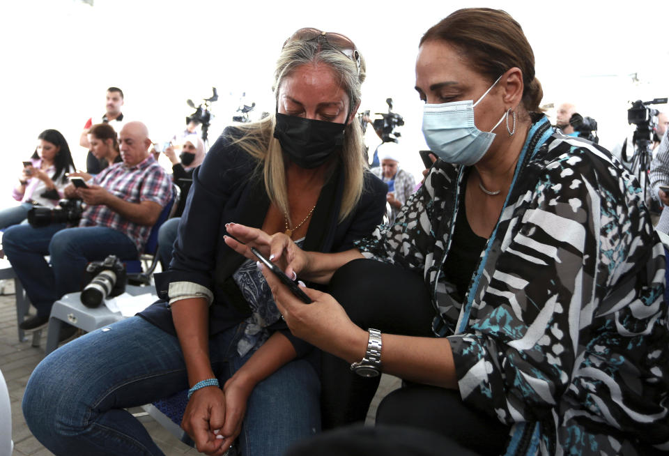 Relatives of two former officials accused of helping Jordanian Prince Hamzah try to overthrow his half-brother King Abdullah II, wait at a state security court for the verdict in their trial, in Amman, Jordan, Monday, July 12, 2021. The court sentenced the two to 15 years in prison. Bassem Awadallah, who has U.S. citizenship and once served as a top aide to King Abdullah II, and Sharif Hassan bin Zaid, a member of the royal family, were found guilty of sedition and incitement charges. (AP Photo/Raad Adayleh)