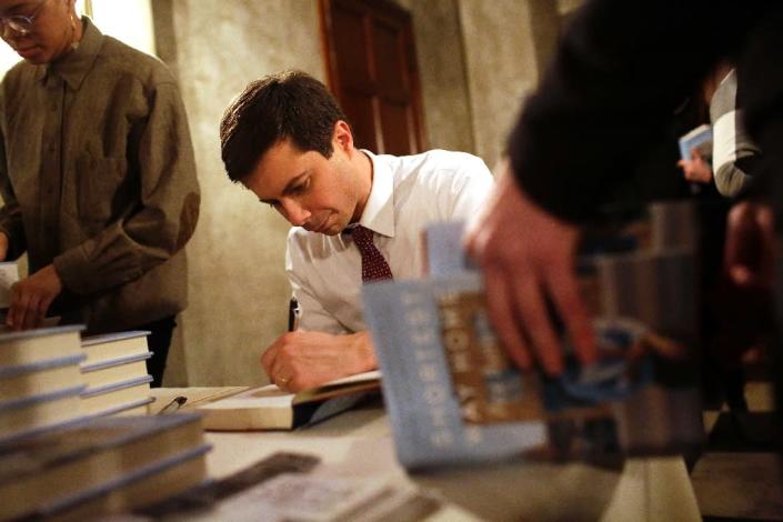 Pete Buttigieg, seen here signing copies of his book "Shortest Way Home," has positioned himself as a unifier after the divisive Donald Trump era (AFP Photo/Joshua Lott)
