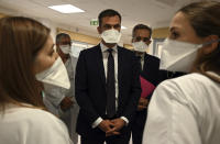 French Health Minister Olivier Veran, center, listens to medical workers of La Timone public hospital, Friday Sept. 25, 2020 in Marseille, southern France. Angry restaurant and bar owners are demonstrating in Marseille to challenge a French government order to close all public venues as of Saturday to battle resurgent virus infections. On Thursday France reported more than 16,000 new infections, and more than 10% of intensive care beds nationwide are now occupied by COVID-19 patients. (Christophe Simon, Pool via AP)