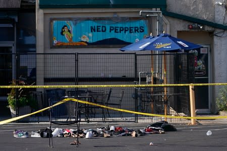 Shoes are piled in the rear of Ned Peppers Bar at the scene after a mass shooting in Dayton